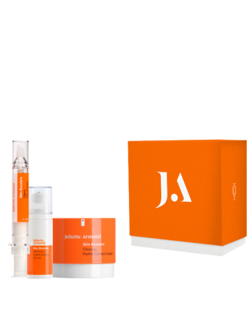 Skincare product set with orange packaging and 'J.A' logo