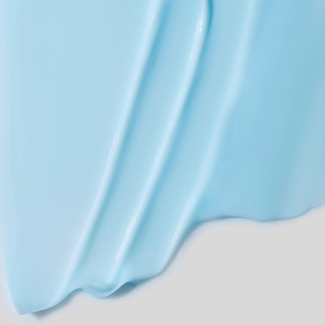 Close-up of light blue cream on a white background