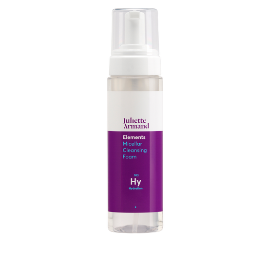 Skincare foam bottle with purple label on a white background