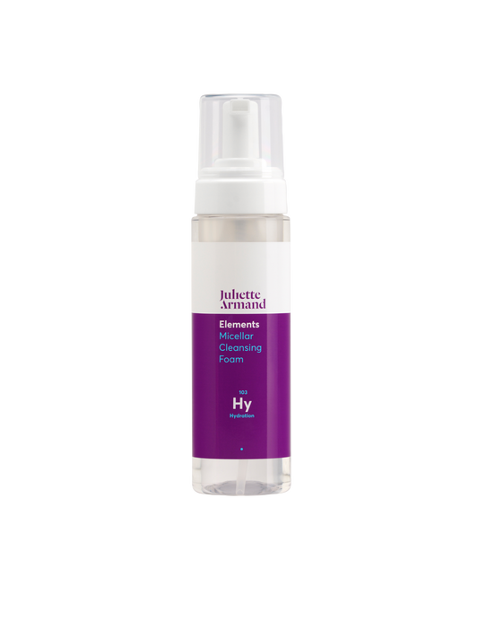 Skincare foam bottle with purple label on a white background