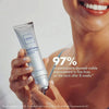 Person holding an Obagi ELASTIderm product with a visible improvement claim on a plain background