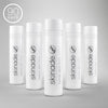 Set of white skincare bottles with 'skinade' branding on a gray background