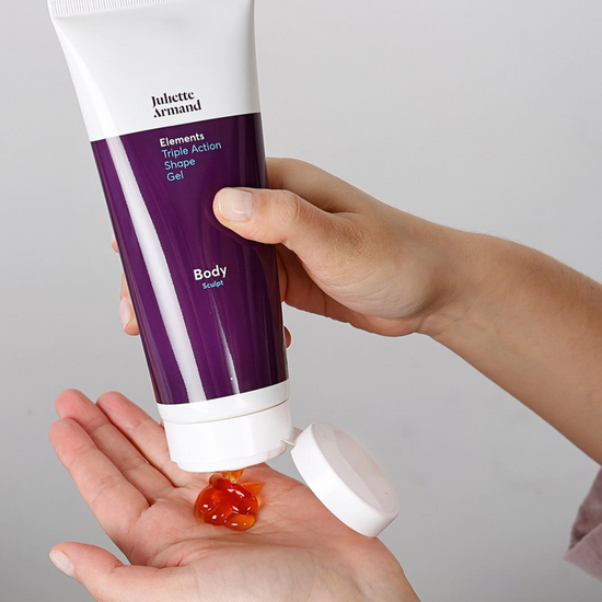 Hand holding a tube of Juliete Armand body gel with a small amount on the palm